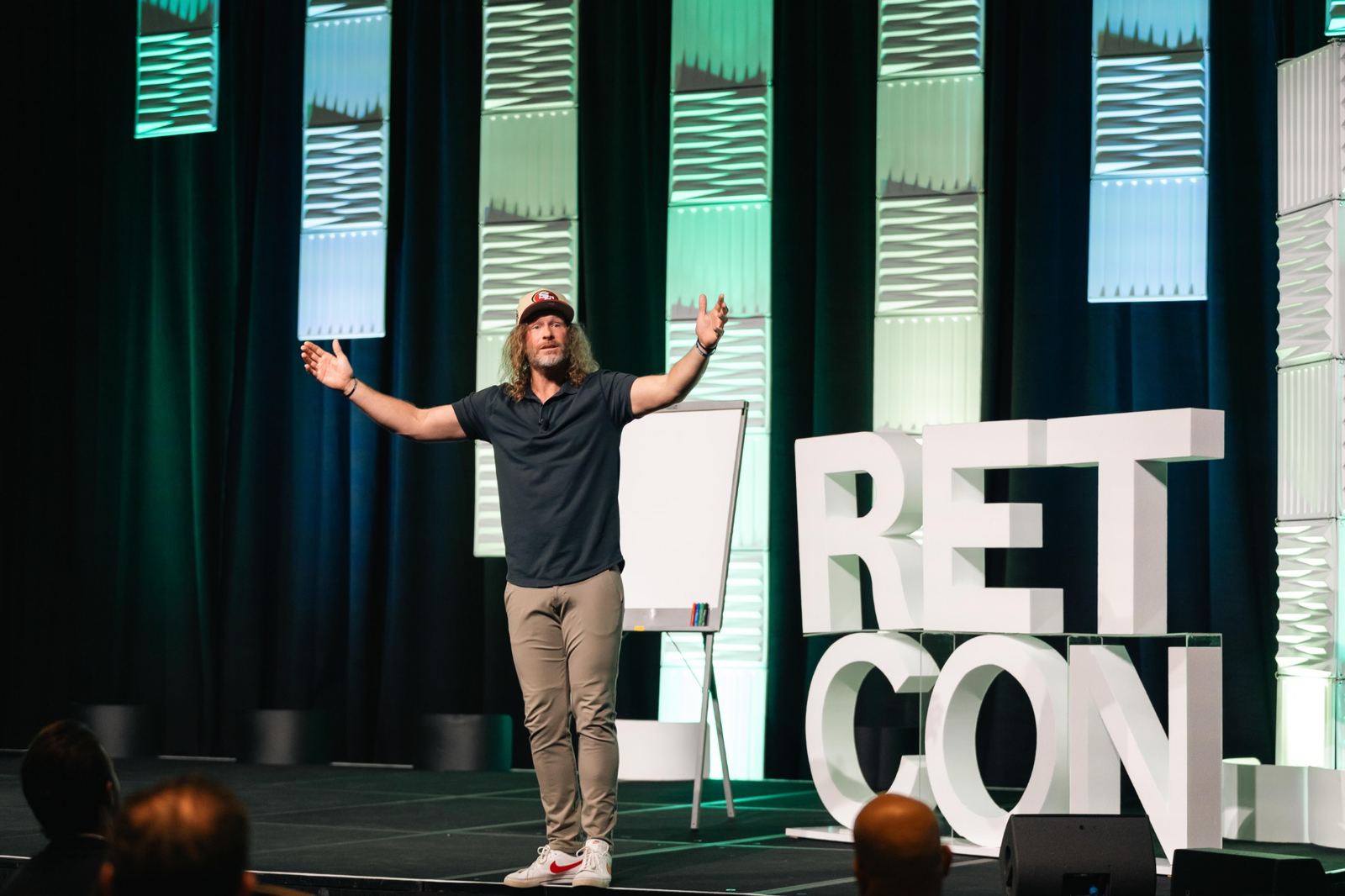 RETCON speaker presenting on stage
